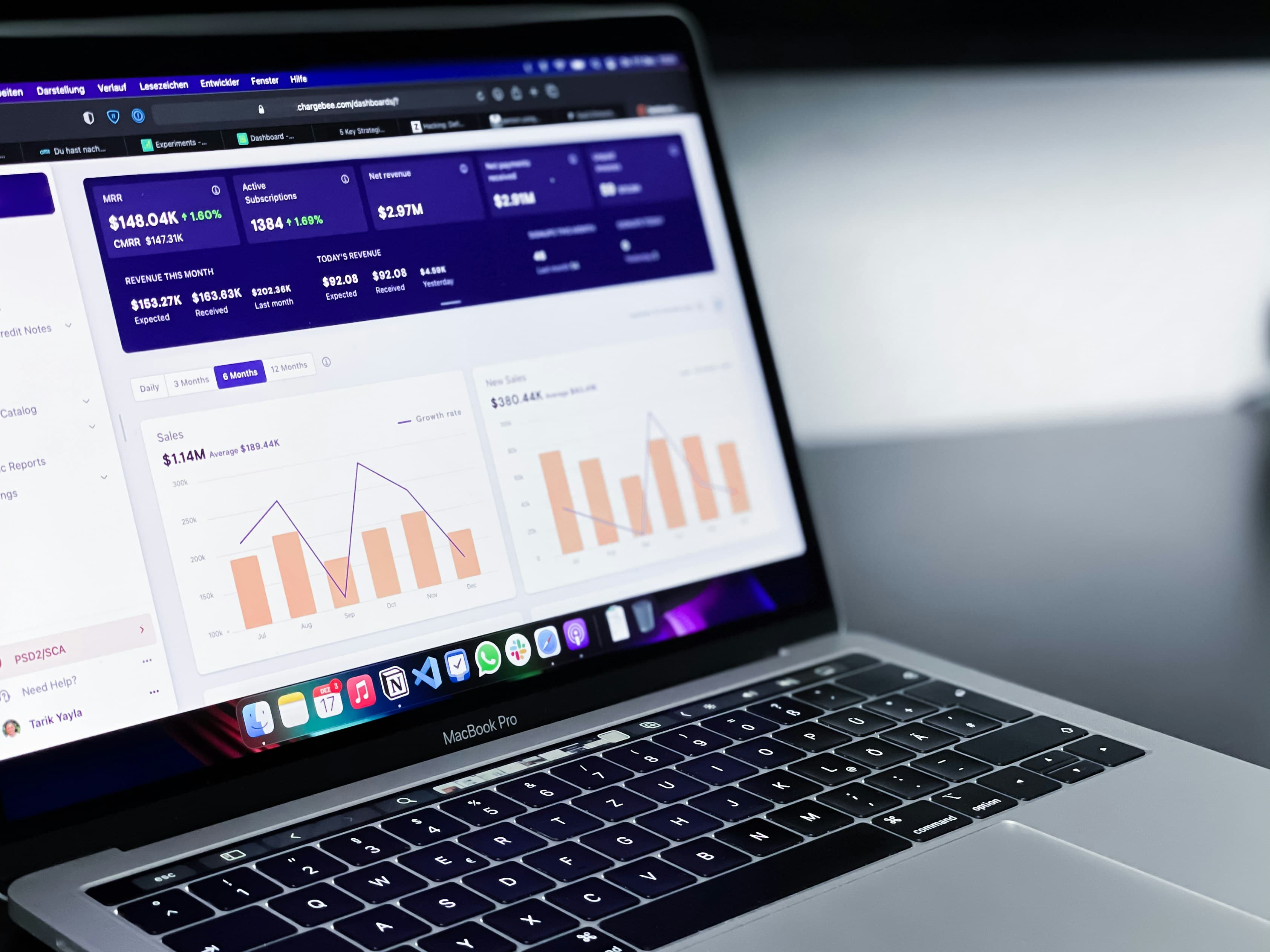Dashboard displaying sales and revenue analytics on a MacBook laptop.